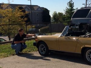 Steven Paul the owner of Test Drive Technologies performing a pre-purchase classic car inspection on a MG