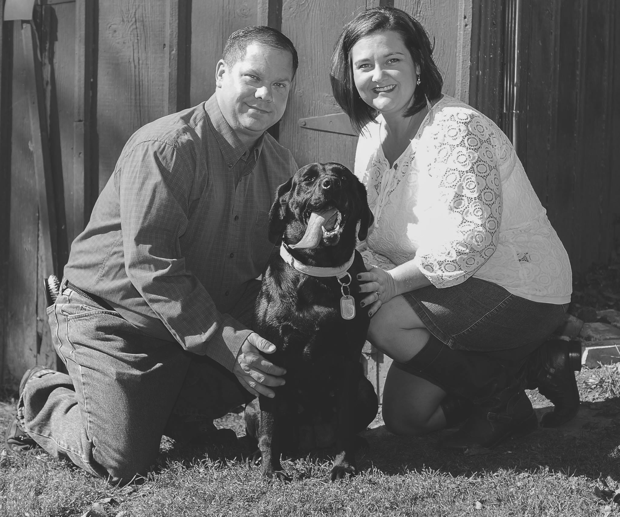 Husband. Wife, professional photo, black lab, tongue out, black and white photo